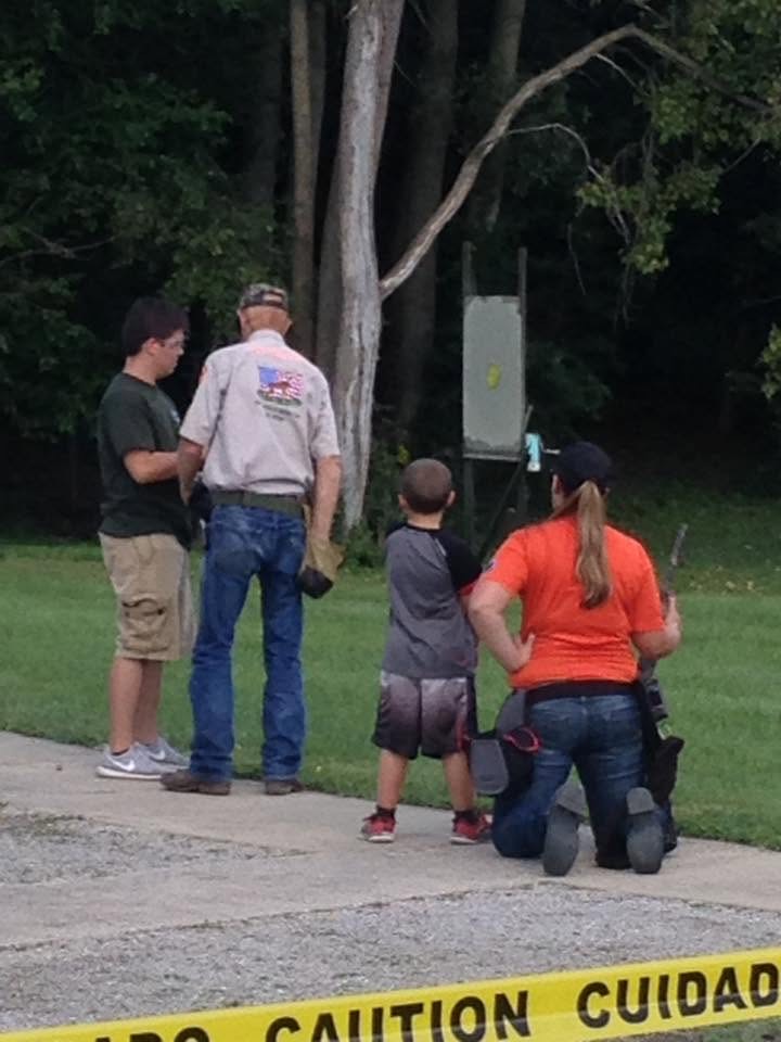 Instructors working with young shooters at the range